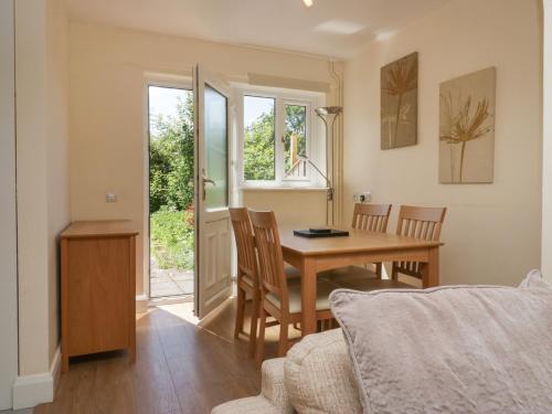 a kitchen and dining room with a table and chairs at 12 Eamont Park in Penrith