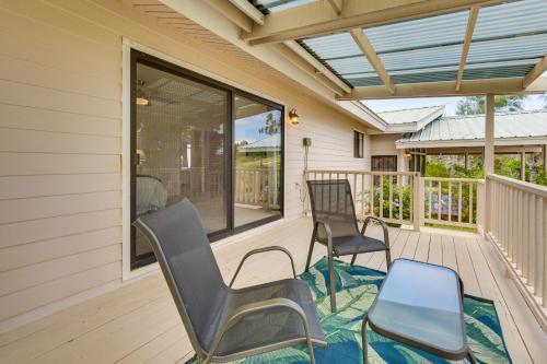 a screened porch with chairs and awning at Secluded Waimea Hideaway with Lanai and Views! in Waimea