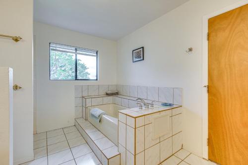 a bathroom with a tub and a sink at Secluded Waimea Hideaway with Lanai and Views! in Waimea