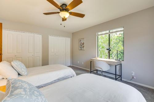 a bedroom with two beds and a ceiling fan at Secluded Waimea Hideaway with Lanai and Views! in Waimea