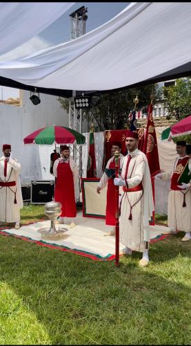 a group of people standing under a tent with umbrellas at villa victoria in Tetouan