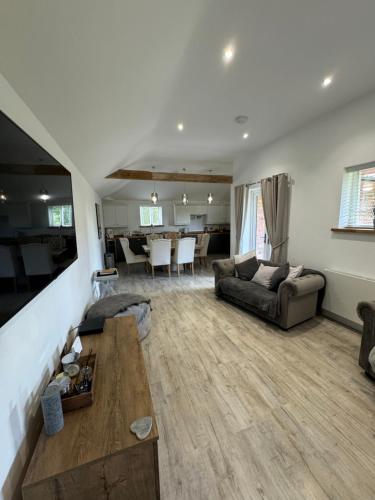 a living room with a couch and a table at Boundary Cottage in Middleton