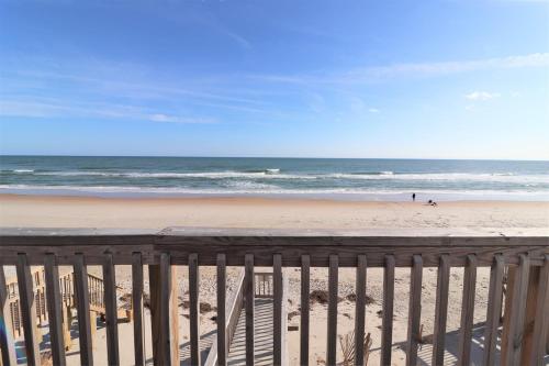 a view of the beach from a balcony at On Slow Time in West Onslow Beach
