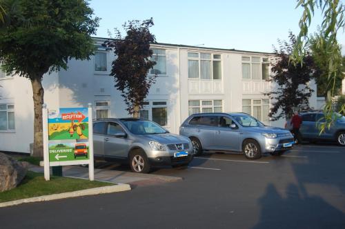 three cars parked in a parking lot in front of a building at Dawlish Warren Welcome family holiday park South Devon Willow villa Welcome2Warren in Dawlish Warren