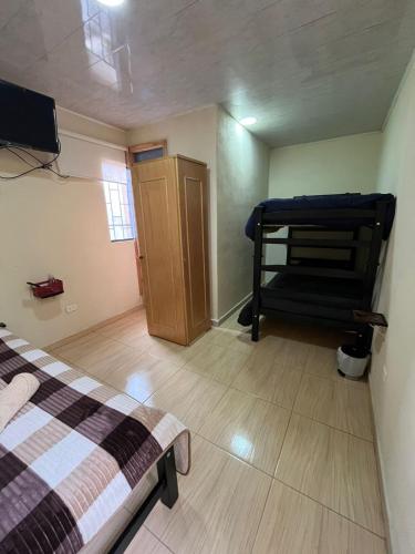 a small room with a bed and a bunk bed at HOTEL BS in Nemocón