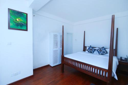 a bedroom with a bed in a room at Palazzo Lake Gregory in Nuwara Eliya