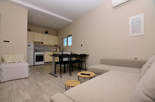 a living room and kitchen with a couch and a table at Villa Yvonne by EY Villas in Parga