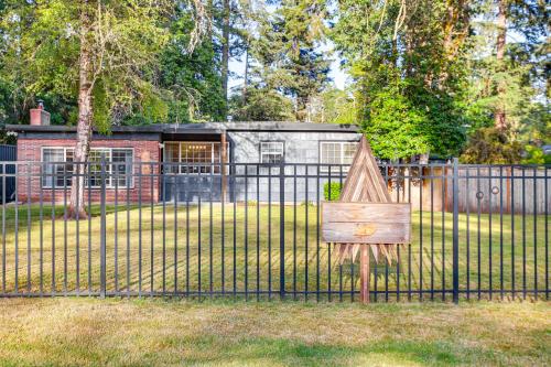 a fence with a sign in front of a building at Tacoma Retreat with Fire Pit - Walk to Lake Access! in Tacoma