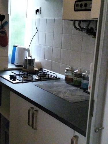 a kitchen with a stove and a counter top at Casa Matilde in Genova