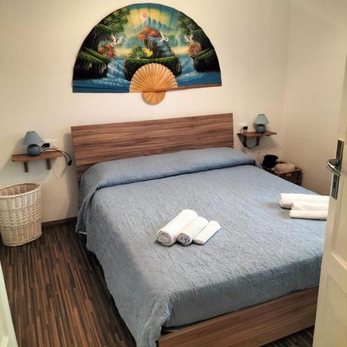 a bedroom with a bed with two towels at Casa Matilde in Genova