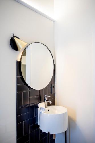 a bathroom with a white sink and a mirror at Citrea Santander in Santander