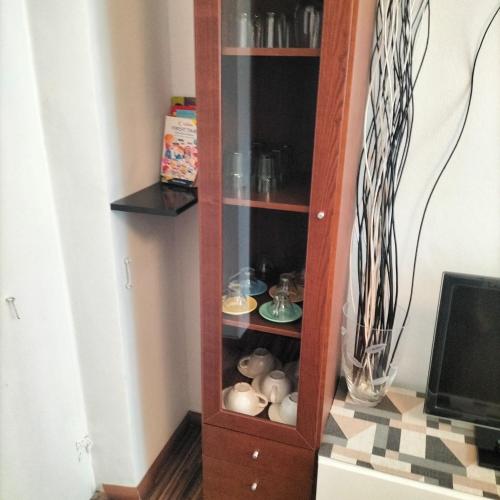 a wooden book shelf with balls in it at Casa Matilde in Genova