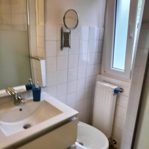 a bathroom with a sink and a toilet and a mirror at Casa Matilde in Genova