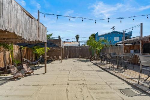 a patio with chairs and tables and a fence at Good Life Resorts in San Diego