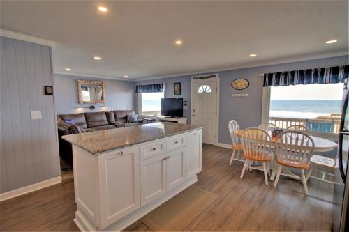 a kitchen and dining room with a table and chairs at Endless Summers in North Topsail Beach