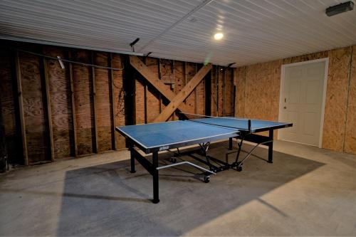 a ping pong table in a room with a ceiling at Endless Summers in North Topsail Beach