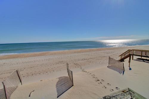 a volleyball court on a beach with the ocean at Just Chill'n in North Topsail Beach