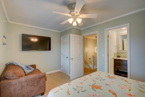 a bedroom with a bed and a ceiling fan at Living on the Edge Too in North Topsail Beach