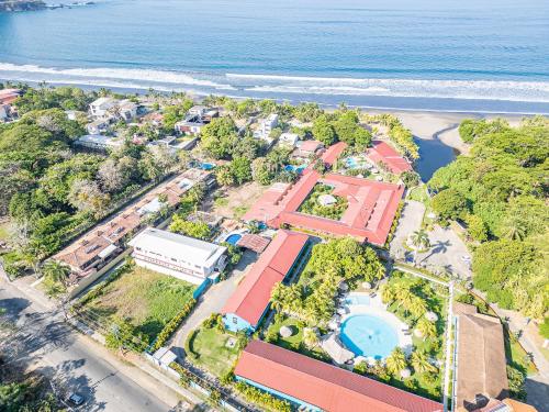 an aerial view of a resort next to the beach at Beach Break Resort & CR Surf Camp in Jacó