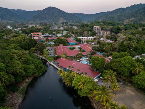 an aerial view of a town next to a river at Beach Break Resort & CR Surf Camp in Jacó