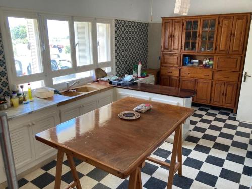 a kitchen with a wooden table in a kitchen at Maison front de mer à Kerkouen in Kerkouene