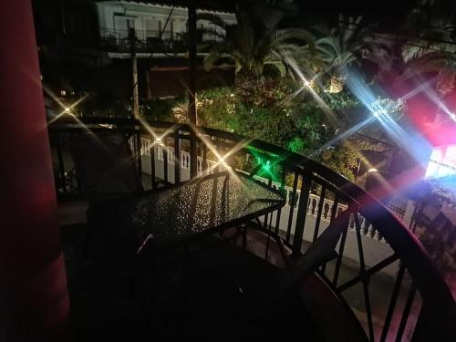 a table on a balcony at night with lights at Irini&Stefanos Toroni, Greece in Toroni
