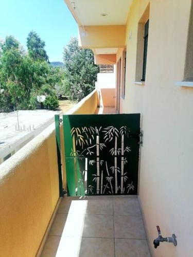 a door with a painting on the side of a building at Irini&Stefanos Toroni, Greece in Toroni