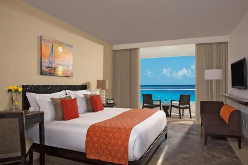 a bedroom with a bed and a view of the ocean at Krystal Grand Cancun All Inclusive in Cancún