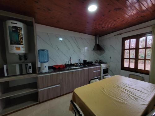 a kitchen with a bed and a sink in a room at Hotel Casa Grande in Pareditas