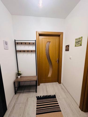 a hallway with a wooden door and a rug at Shtastliveca Guest Apartment in Velingrad