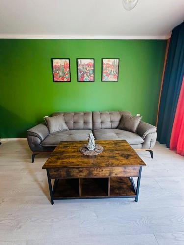 a living room with a couch and a coffee table at Shtastliveca Guest Apartment in Velingrad
