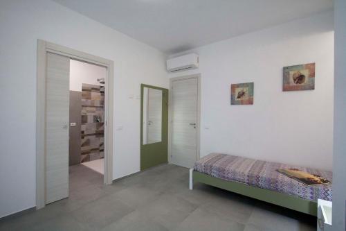 a bedroom with a bed and a walk in closet at villa grecale in Castellammare del Golfo