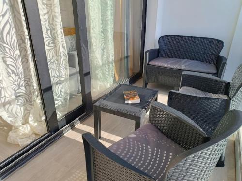 a balcony with two chairs and a table and a chair and a table sidx sidx at Deluxe Arguineguin Beach in Arguineguín