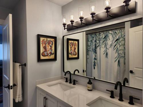 a bathroom with a sink and a large mirror at Spacious House in Federay Way, WA - Close to everything! in Federal Way