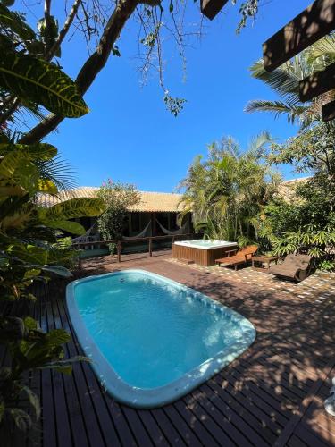 a swimming pool in the yard of a house at Pousada da Praia in Garopaba