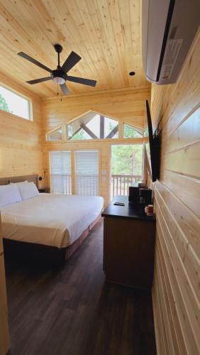 a bedroom with a bed and a ceiling fan at Cabins with a Mountain view 5A in Williams