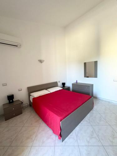 a bedroom with a large bed with a red blanket at Sole&Luna in Armungia