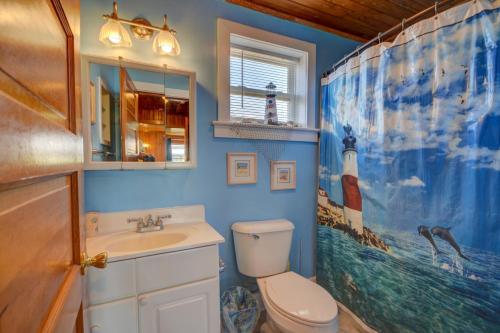 a bathroom with a toilet and a sink and a mirror at Wave To Cool in Surf City