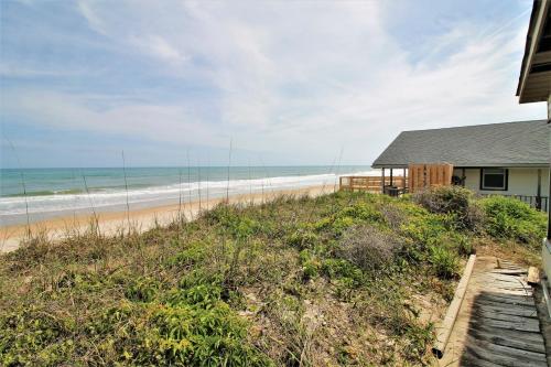 a beach house with a view of the ocean at Wave To Cool in Surf City