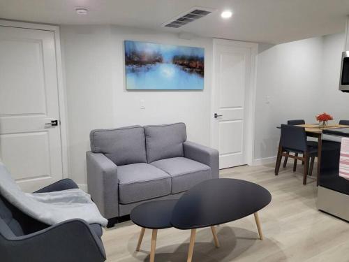 a living room with a couch and a table at Beautiful Comfy Guest Suite in West EDM in Edmonton