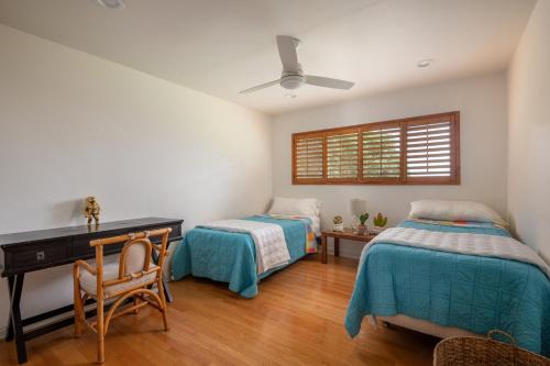 a bedroom with two beds and a desk and a window at La Jolla Shores Family Getaway in San Diego