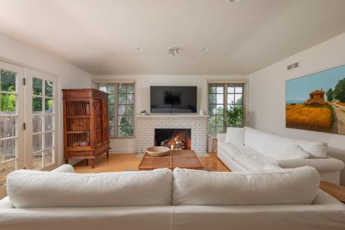 a living room with a white couch and a fireplace at La Jolla Shores Family Getaway in San Diego