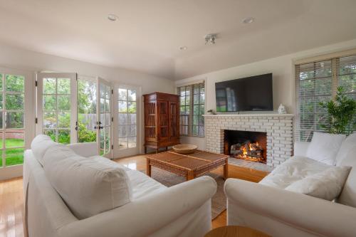 a living room with white furniture and a fireplace at La Jolla Shores Family Getaway in San Diego