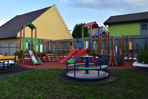 a playground with a bunch of different colored slides at Apartmány Žakovce & SPA in Veľká Lomnica