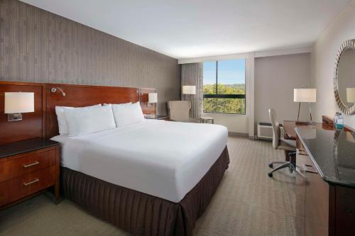 a large white bed in a hotel room at Sonesta Charlotte Lower South End in Charlotte