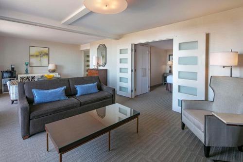 a living room with a couch and a table at Sonesta Charlotte Lower South End in Charlotte