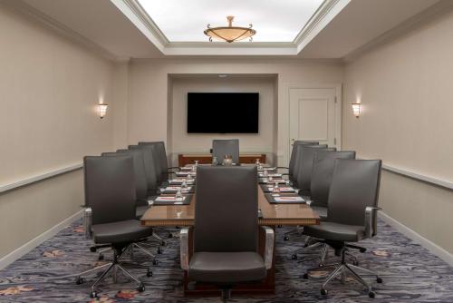 a conference room with a long table and chairs at Sonesta Charlotte Lower South End in Charlotte