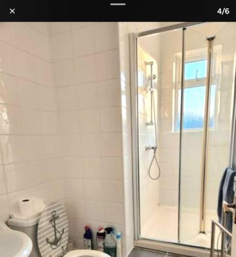a bathroom with a shower and a toilet at One Bed Comfort Studio Apartment in Kent