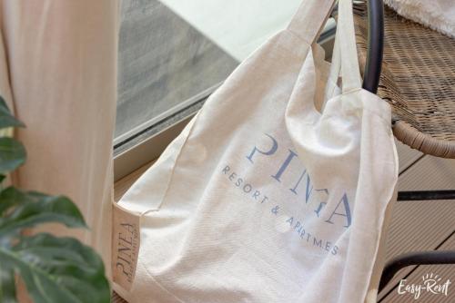 a reusable shopping bag hanging on a window sill at Apartamenty Pinea z widokiem na morze Easy - Rent Apartments in Pobierowo