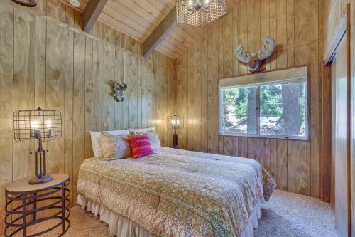 a bedroom with a bed and a window in it at Chic Lake Arrowhead Retreat 4 Seasons of Fun! in Lake Arrowhead